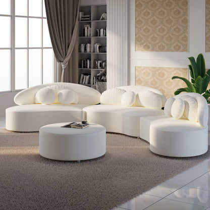Modern white sectional sofa in a living room setting with a bookshelf and decorative elements.