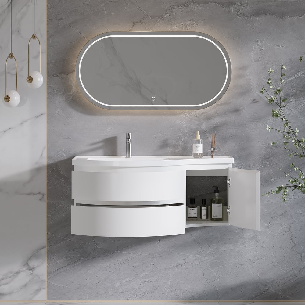 Bathroom vanity with open cabinet, illuminated mirror, and decorative elements on a gray marble wall.