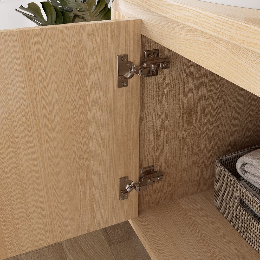 Wooden cabinet with open door showing hinges, interior with basket and folded towels.