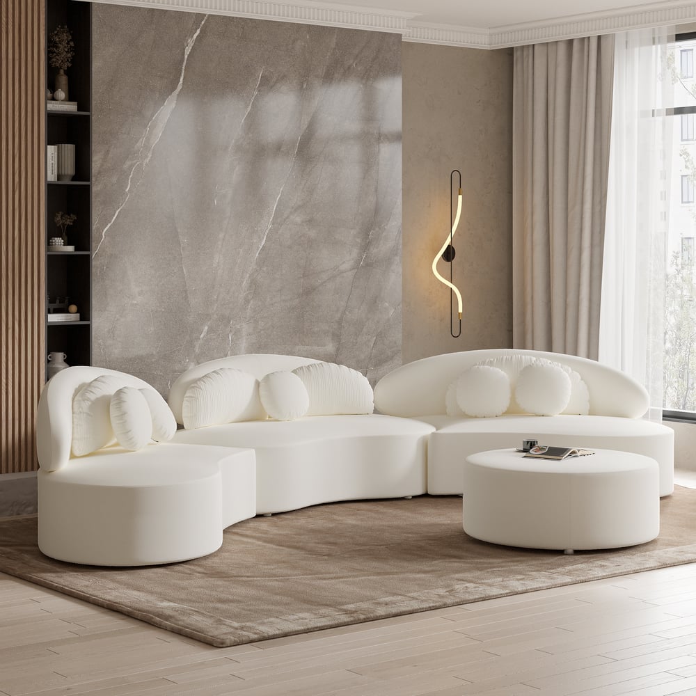 Modern living room with a white sectional sofa and marble wall.