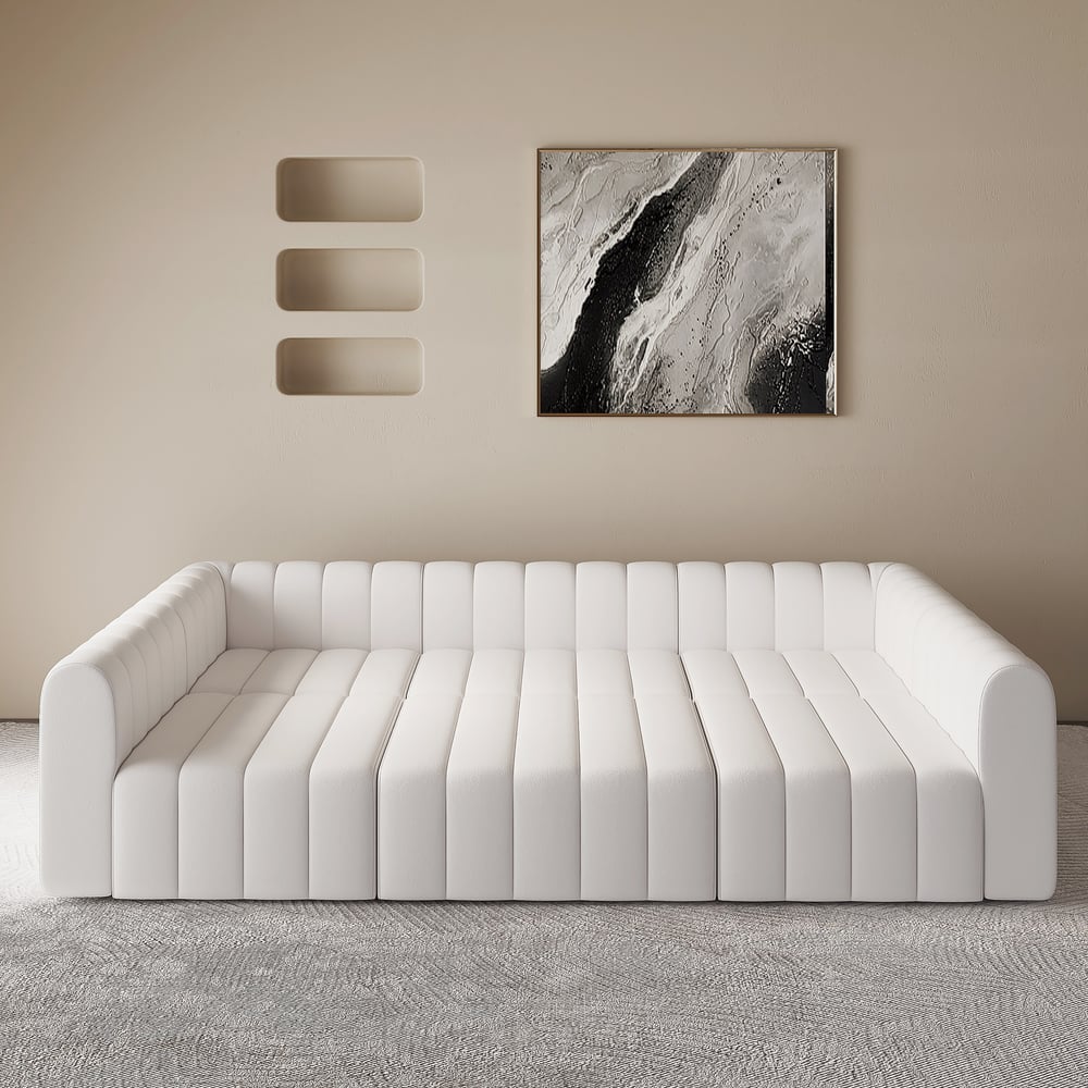 White sofa in a room with abstract art on the wall