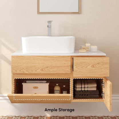 Bathroom vanity with open cabinet showing storage compartments, sink, and towels.