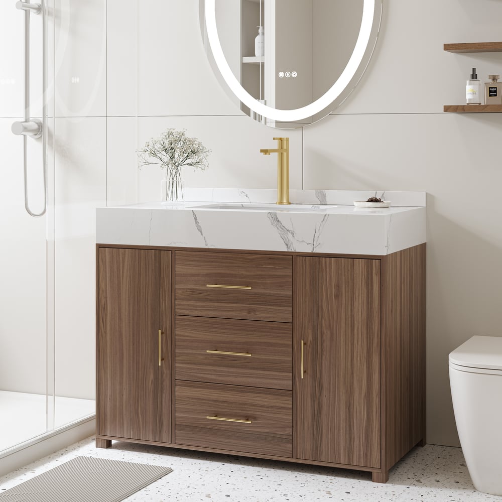 Bathroom vanity with wooden cabinet, white countertop, and gold fixtures.