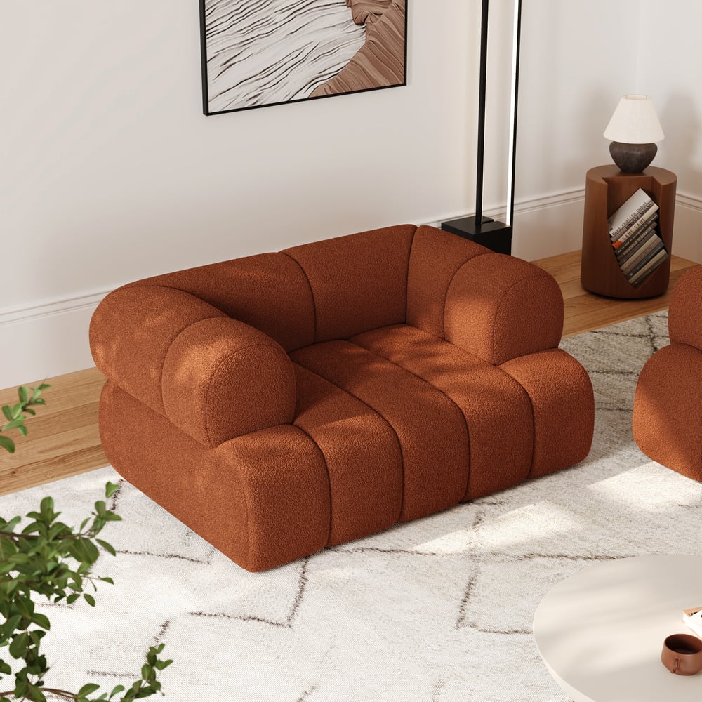 Brown sofa in a living room setting with a rug and plant