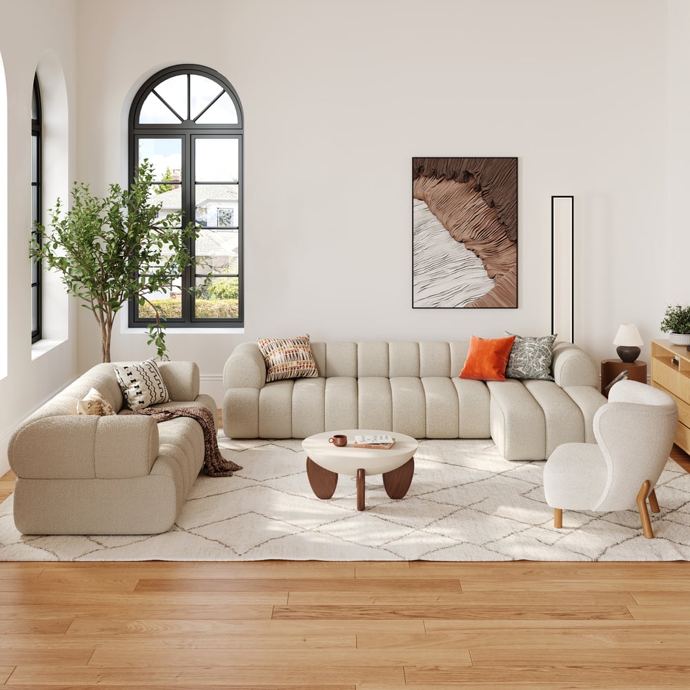 Modern living room with beige sectional sofa, coffee table, and decorative pillows.