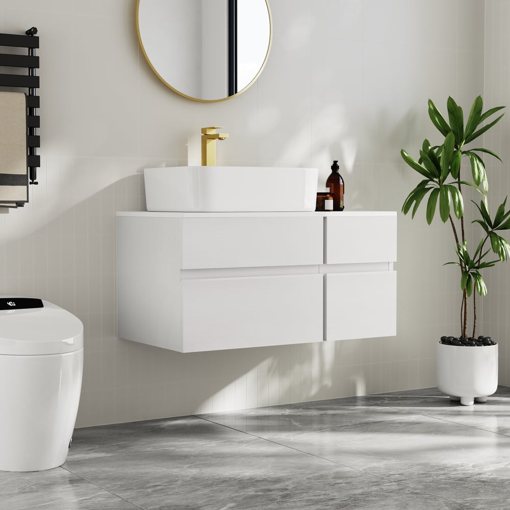 Modern bathroom with white vanity, round mirror, and potted plant.