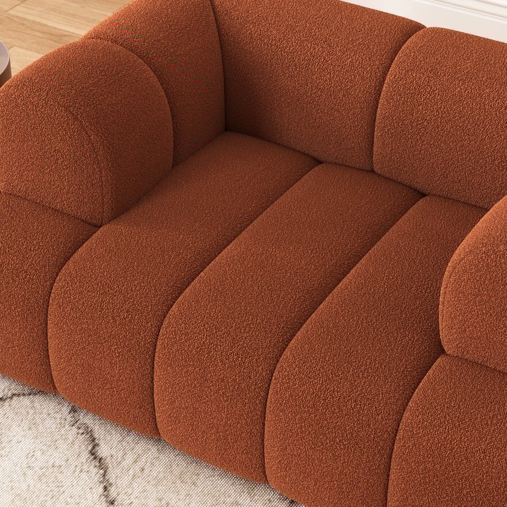 Brown textured sofa with a neutral background