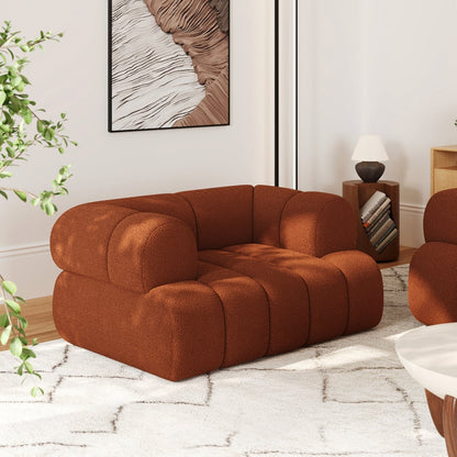 Brown modular sofa in a living room setting with a plant and artwork on the wall.