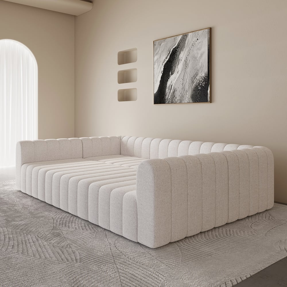 Beige sectional sofa in a modern living room with abstract art on the wall.