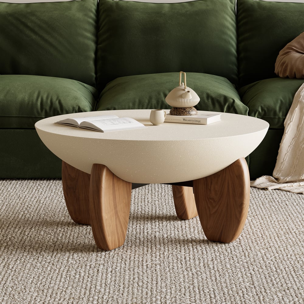 Coffee table with wooden legs in front of a green sofa