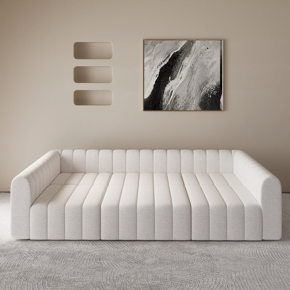 White sofa in a room with abstract art on the wall