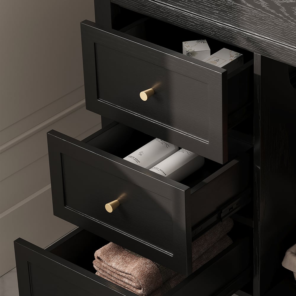 Black dresser with open drawers containing towels and toiletries.