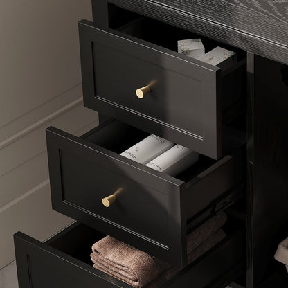 Black dresser with open drawers containing towels and toiletries.