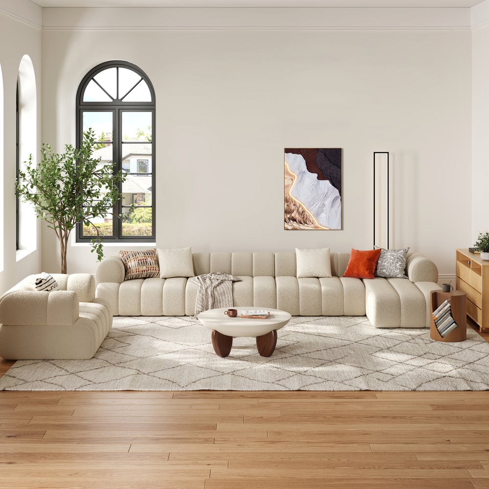 Modern living room with a beige sectional sofa, coffee table, and decorative elements.