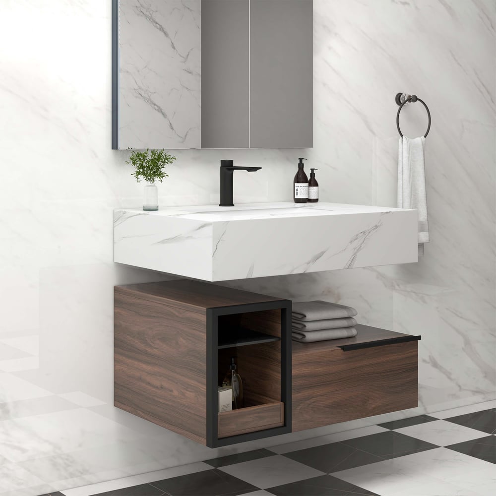 Bathroom vanity with marble countertop, wooden cabinet, and black fixtures.