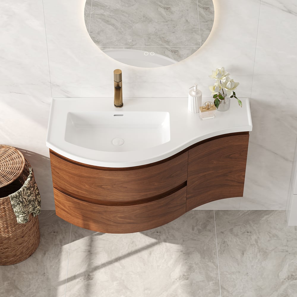 Bathroom vanity with wooden cabinet and white countertop, featuring a round mirror.