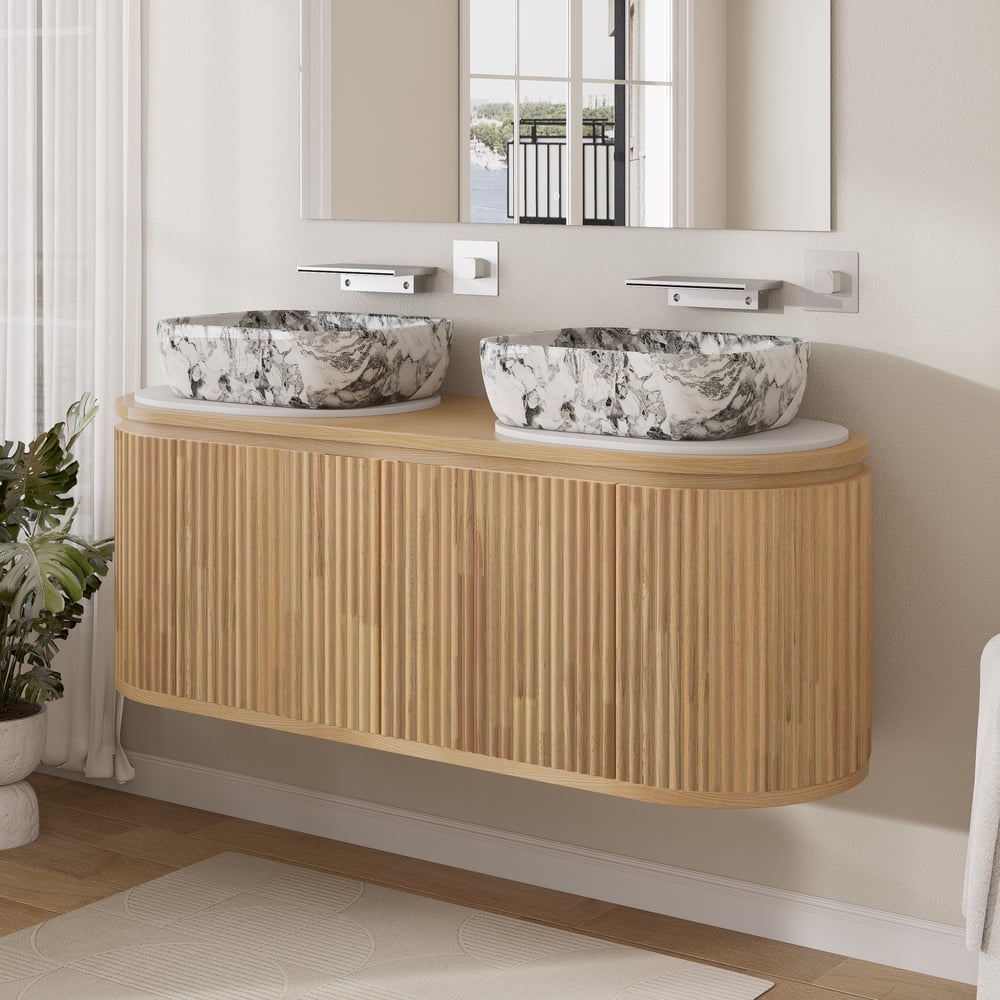 Bathroom vanity with two marble sinks and a mirror.