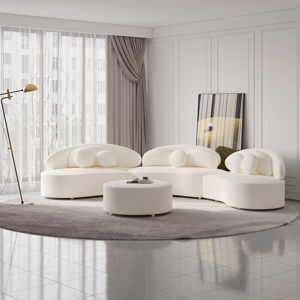 Modern white sofa set in a stylish living room with a rug and lamp.