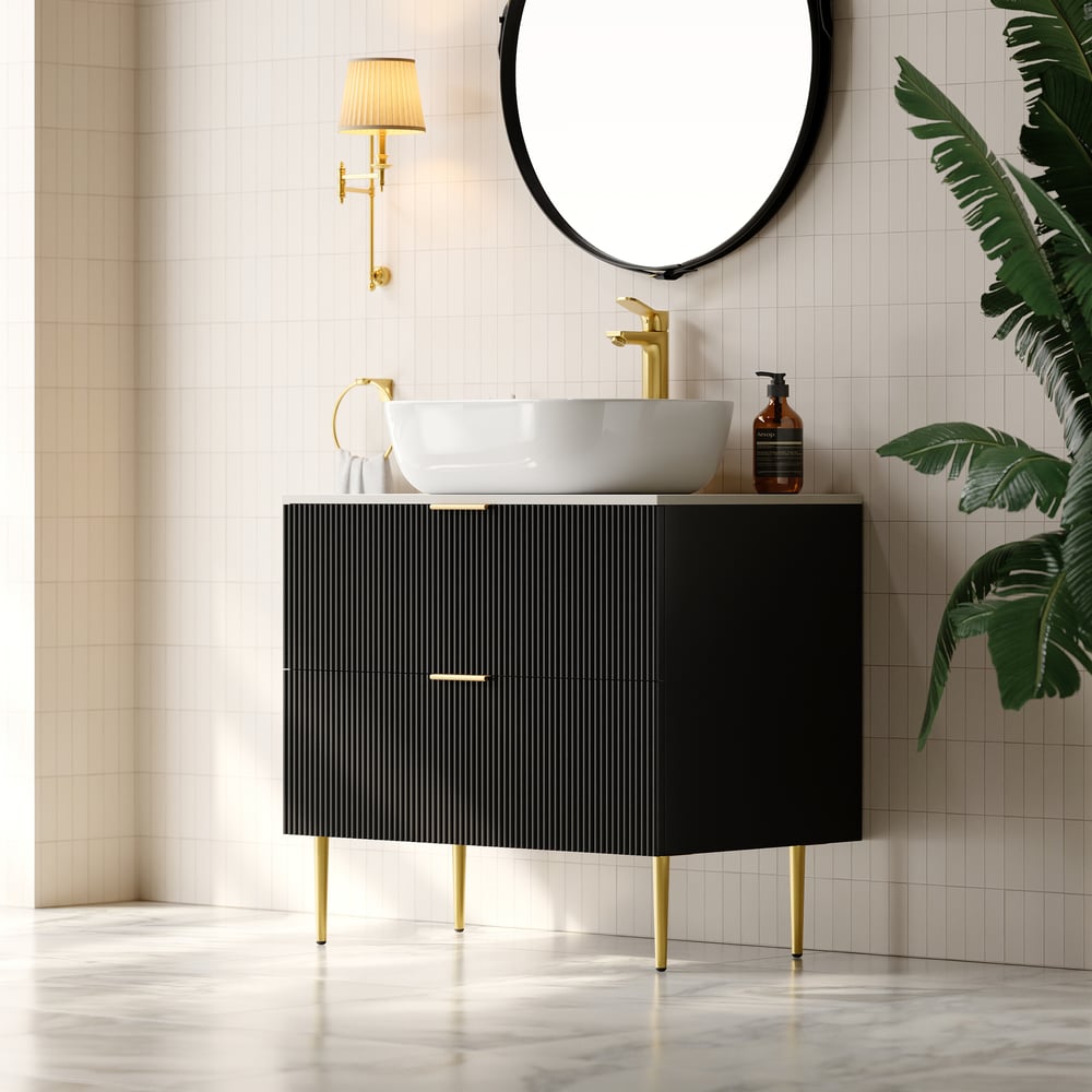 Bathroom vanity with black cabinet, white sink, and gold fixtures.