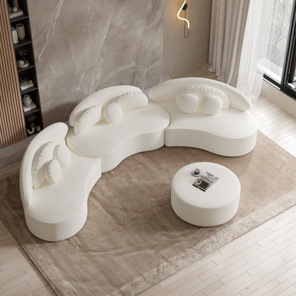 Modern white sofa with a round ottoman in a minimalistic room.