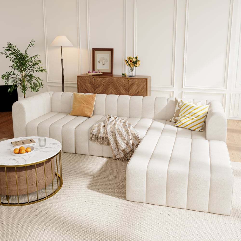 Modern living room with a striped sofa, coffee table, and decorative items.