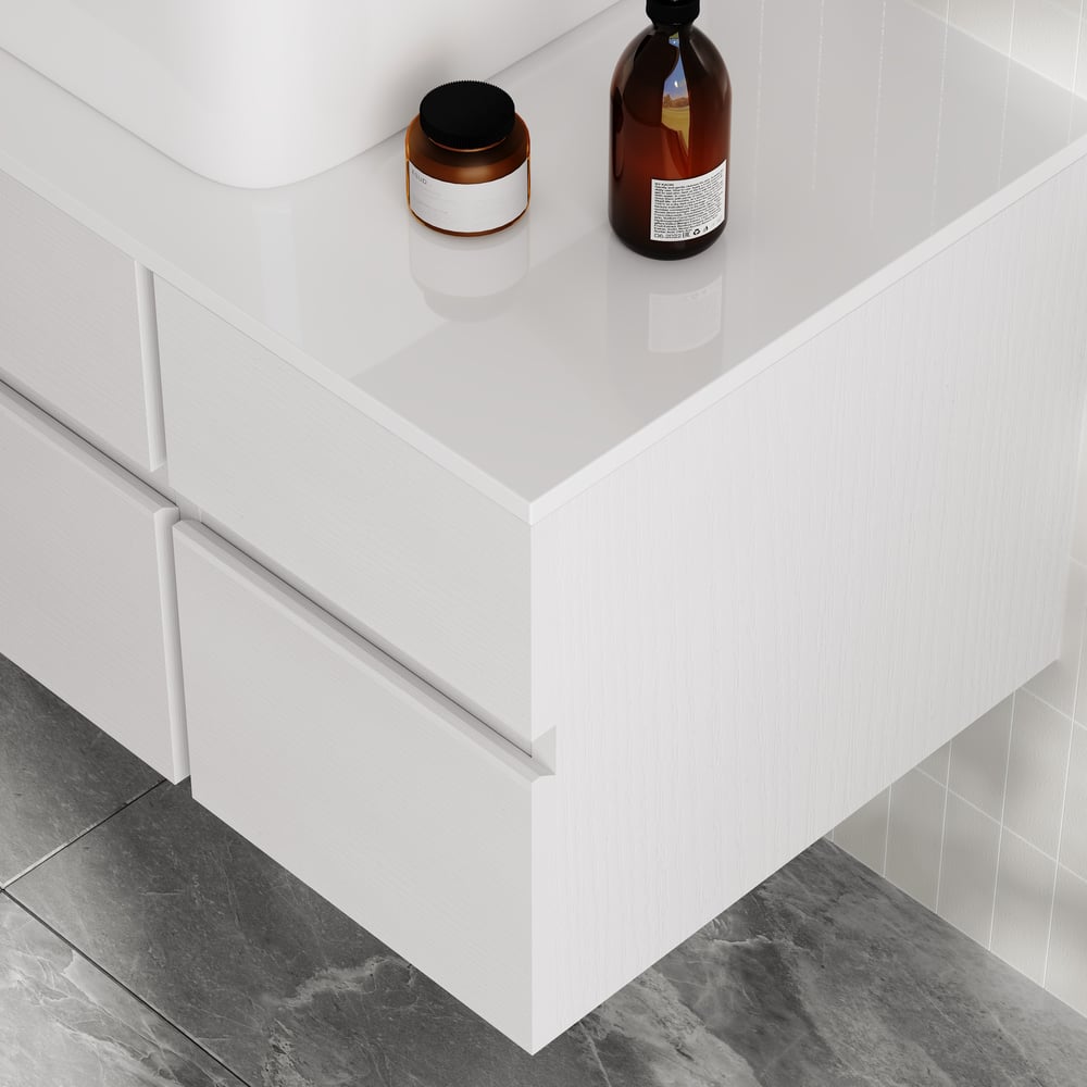 White bathroom vanity with two bottles on a gray tiled floor