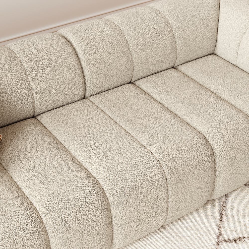 Close-up of a textured beige sofa with a soft, plush finish.