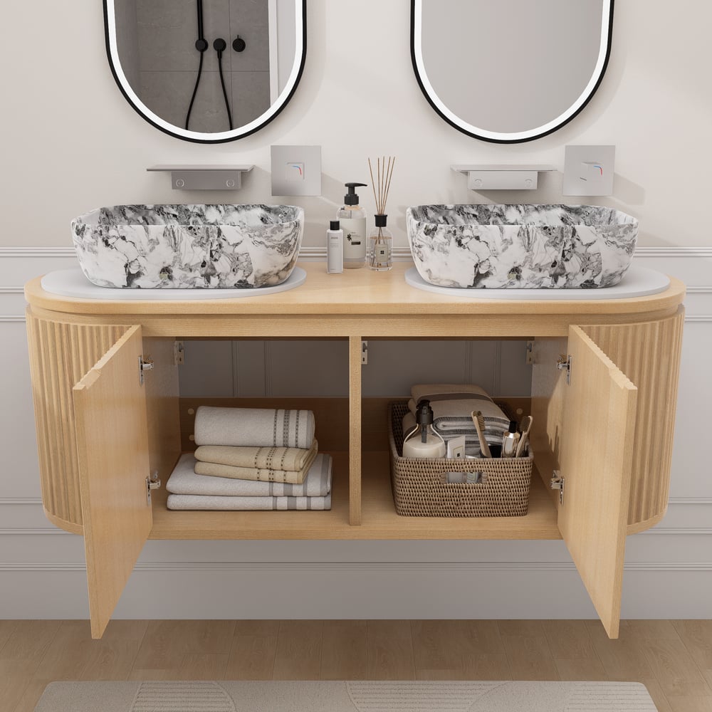 Bathroom vanity with marble sinks, towels, and toiletries.