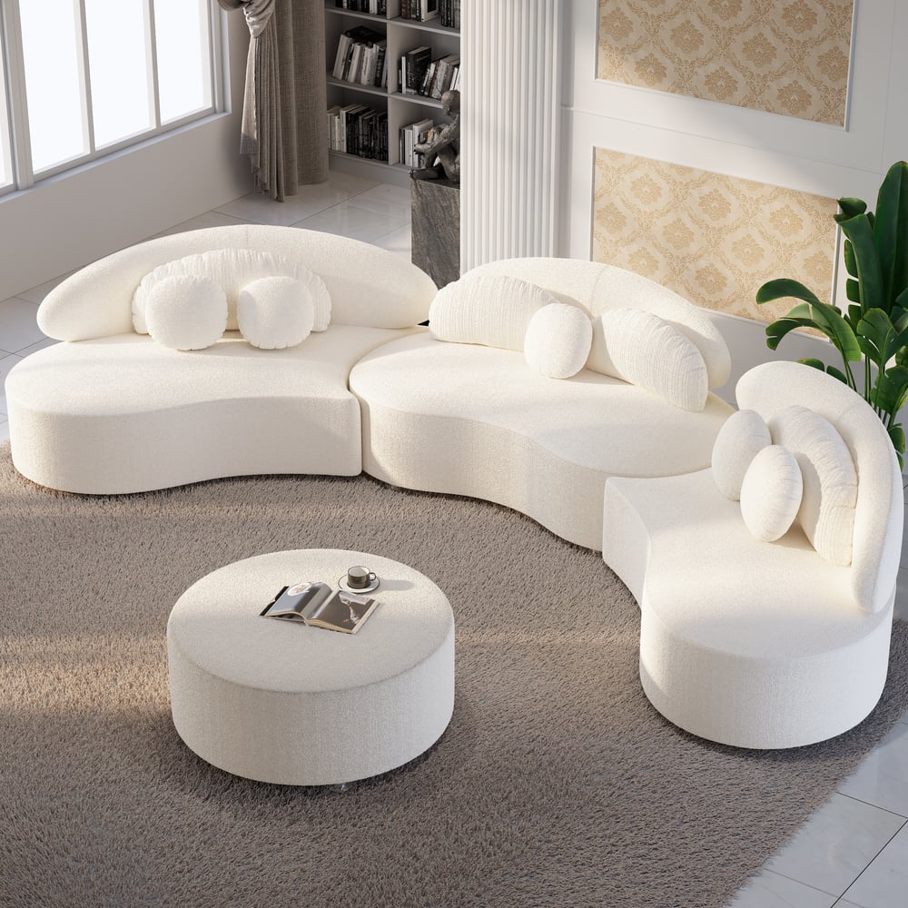Modern white sectional sofa with ottoman in a living room setting