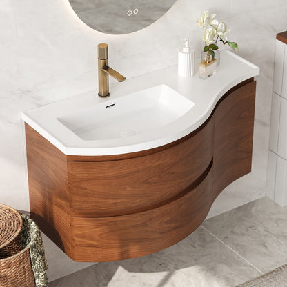 Wooden bathroom vanity with white countertop and gold faucet in a tiled bathroom.