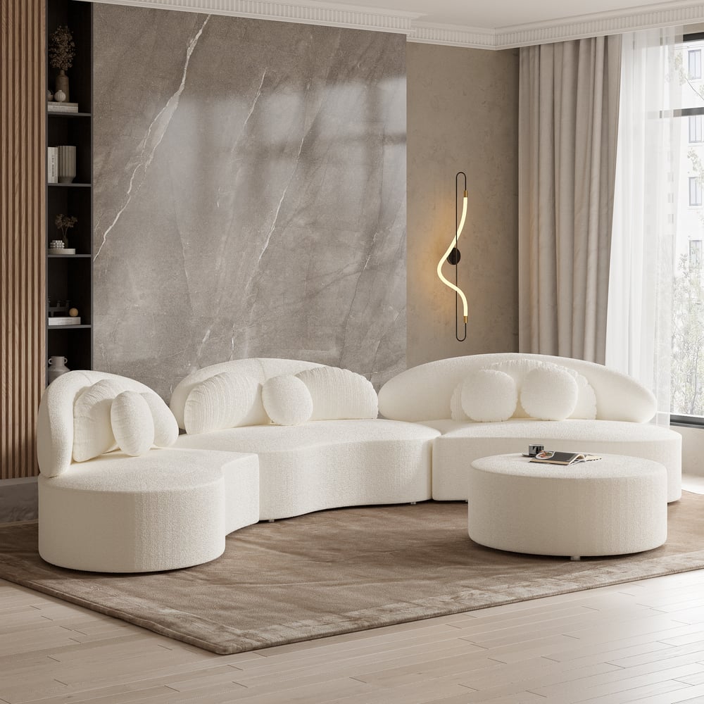 Modern white sofa set in a stylish living room with marble wall and window.