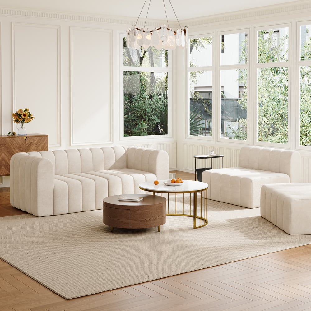 Modern living room with off white sofa, wooden coffee table, and large windows.