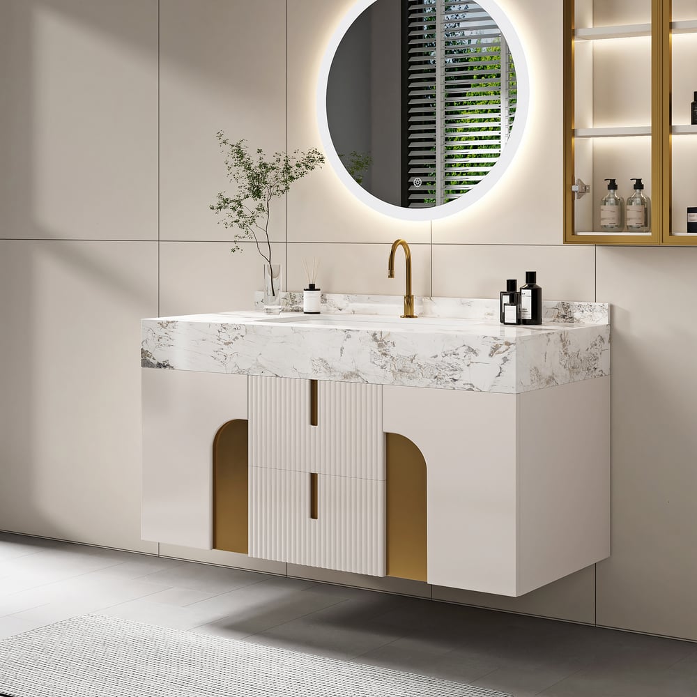 Modern bathroom vanity with marble countertop, gold accents, and round mirror.