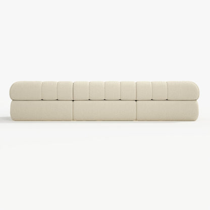 Beige sofa with a quilted design on a white background