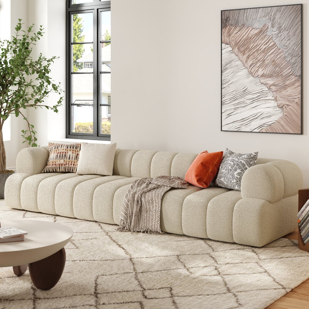 Beige sectional sofa in a living room with a coffee table and decorative pillows.
