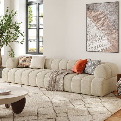 Beige sectional sofa in a living room with a coffee table and decorative pillows.
