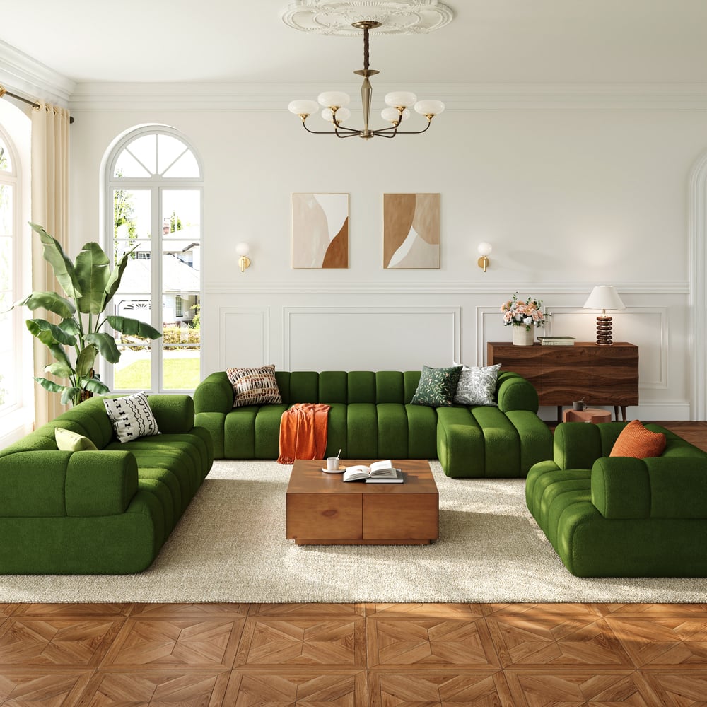 Modern living room with green sectional sofa, wooden coffee table, and decorative elements.