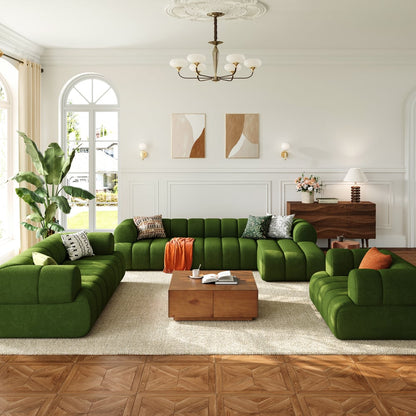 Modern living room with green sectional sofa, wooden coffee table, and decorative elements.