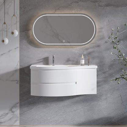 Bathroom vanity with illuminated mirror on a gray marble wall.
