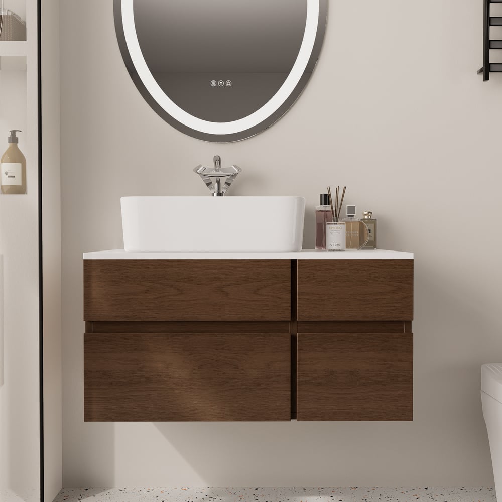 Bathroom vanity with wooden cabinets, white countertop, and round mirror.
