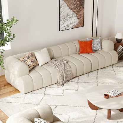 Beige sectional sofa in a living room with decorative pillows and a coffee table.