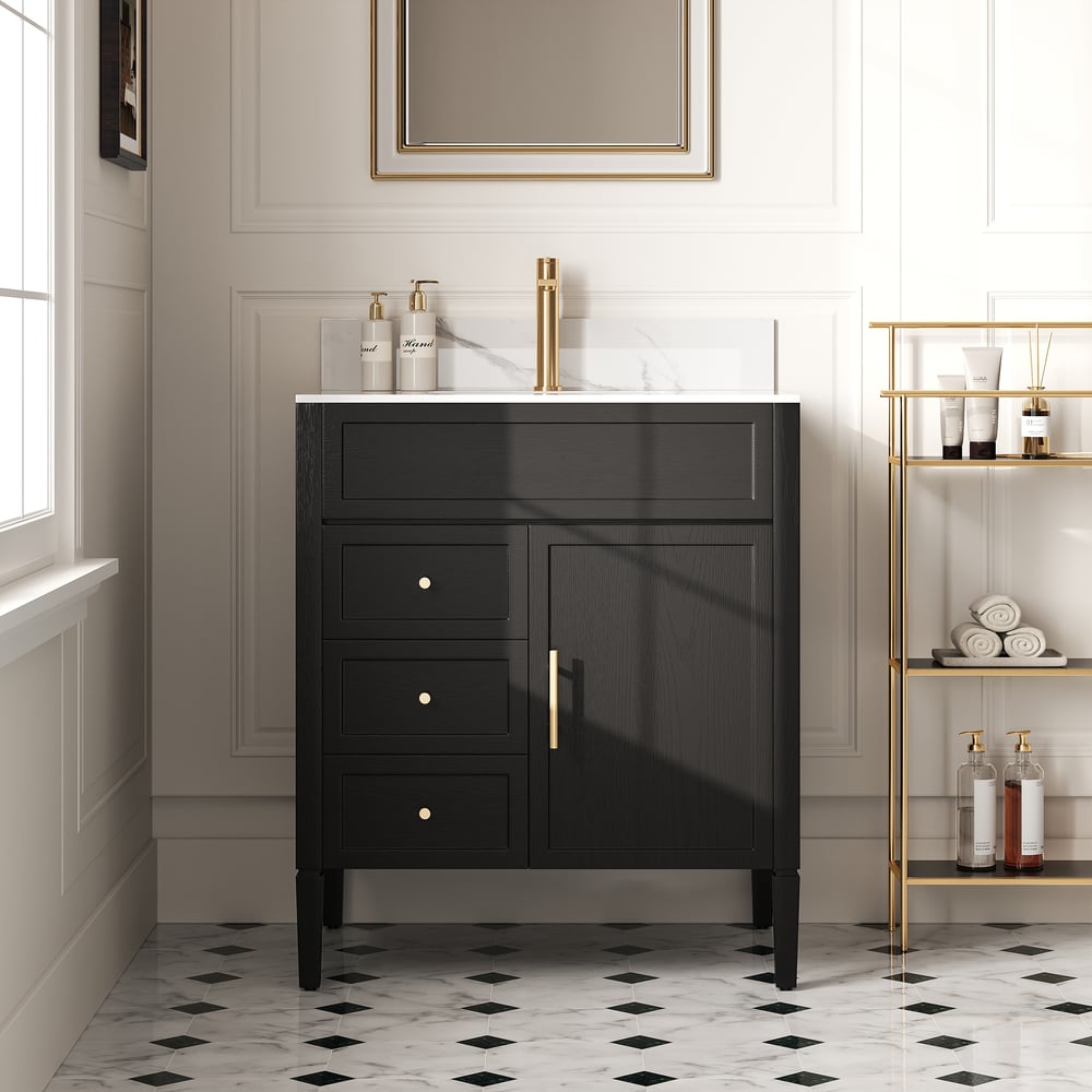 Black bathroom cabinet with gold fixtures in a modern bathroom setting.