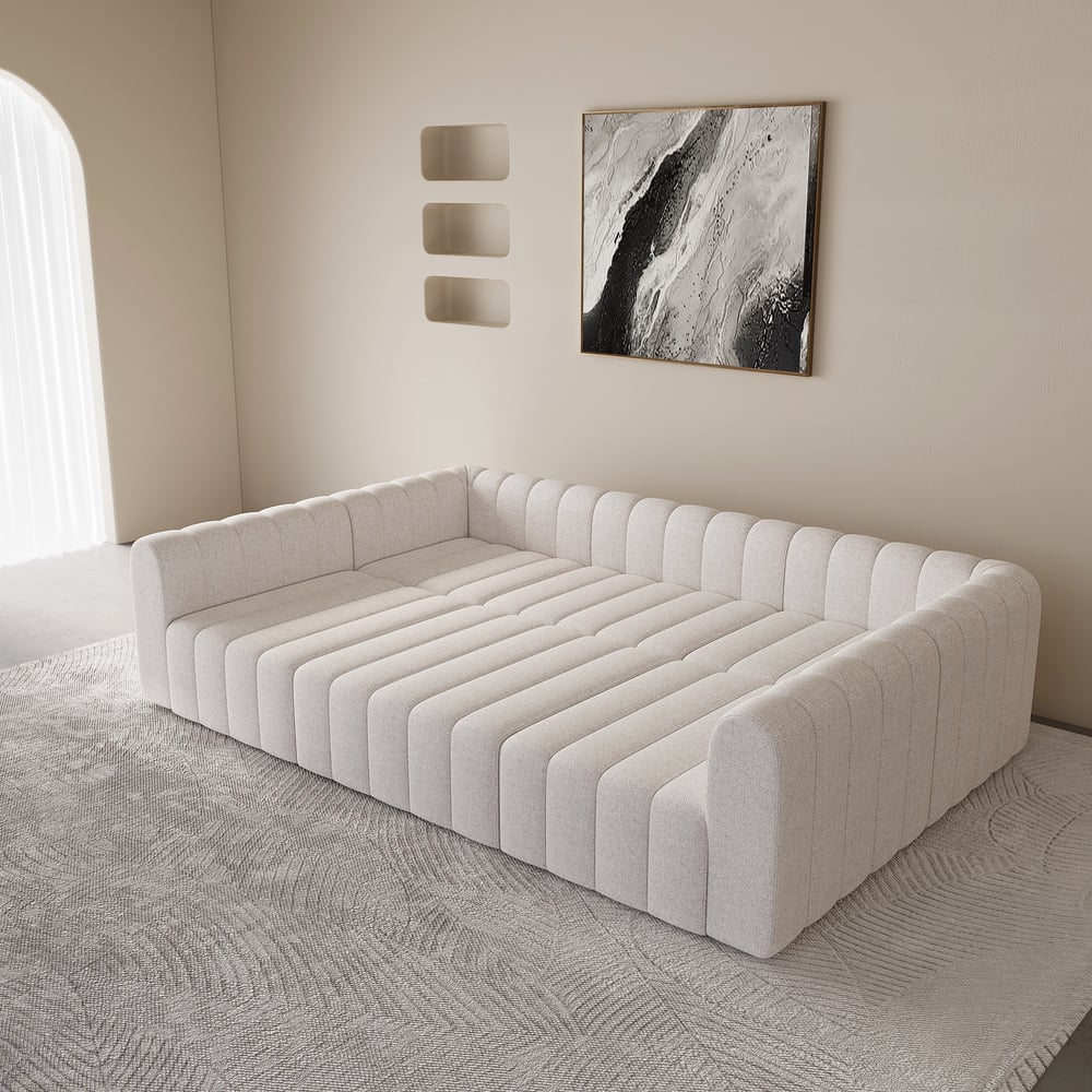 Modern white sofa in a minimalistic room with abstract art on the wall.