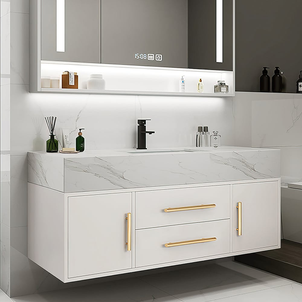 Bathroom vanity with marble countertop, gold handles, and illuminated mirror.