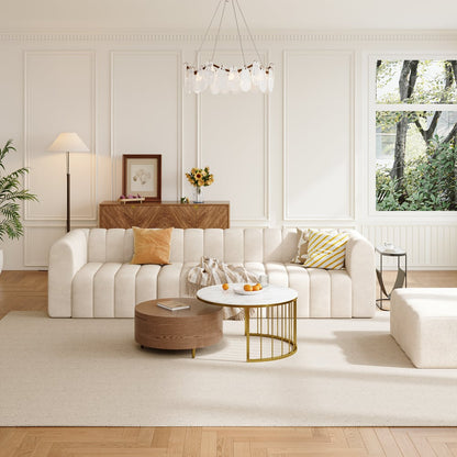 Modern living room with an Off white sofa, wooden coffee table, and decorative elements.
