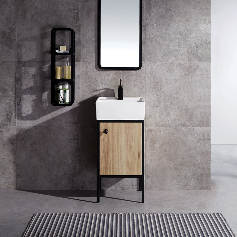 Bathroom vanity with wooden cabinet and white sink against a gray tiled wall.
