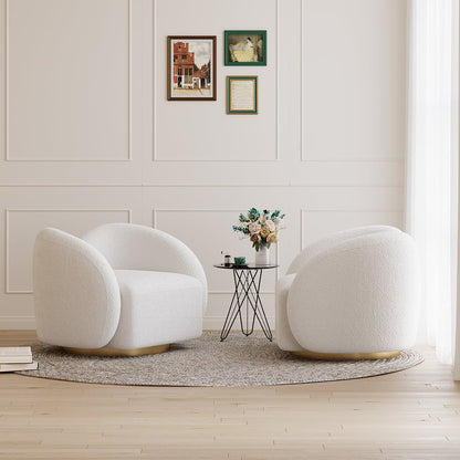 Two white armchairs in a room with a small round table and decorative elements.