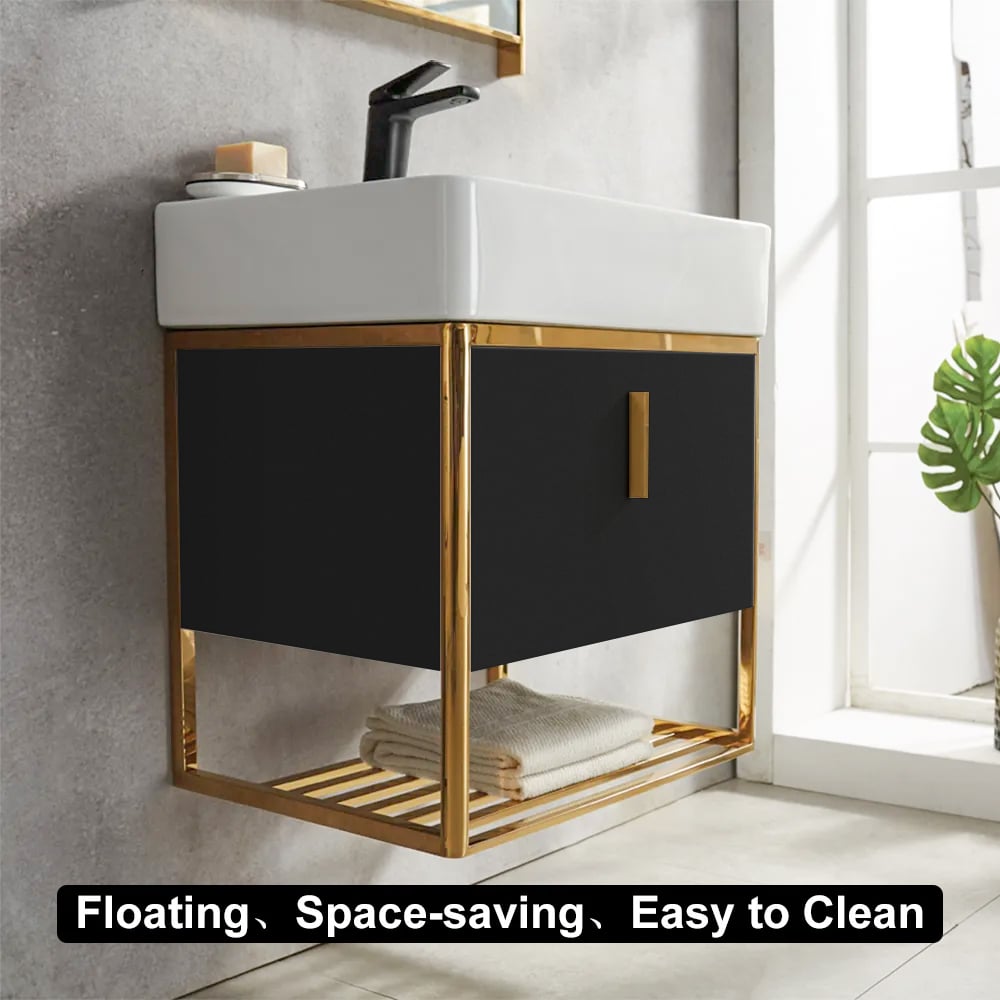 Bathroom vanity with black cabinet and white sink, featuring gold accents.