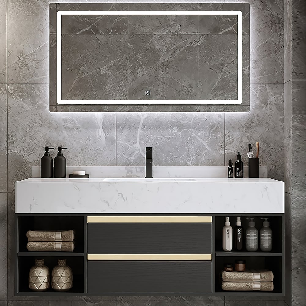 Bathroom vanity with a large mirror above it, featuring various toiletries on a gray tiled wall.