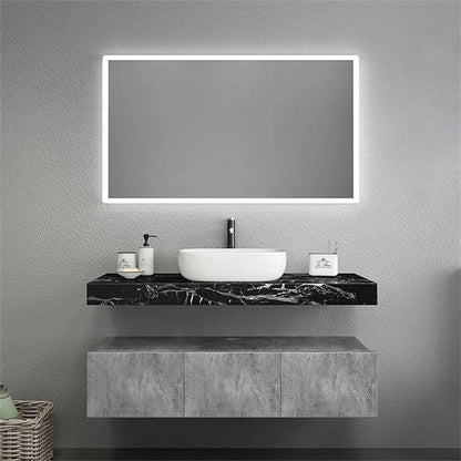 Bathroom vanity with a sink and illuminated mirror on a gray wall.